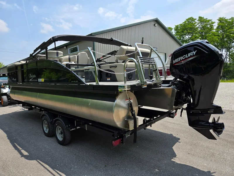 Slide: The Image of 2023 Barletta Cabrio 24UE pontoon boat with Mercury outboard motor on trailer. - 1