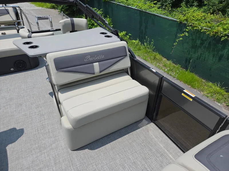 Slide: The Image of 2023 Barletta Cabrio 24UE boat interior with comfortable seating and table. - 13