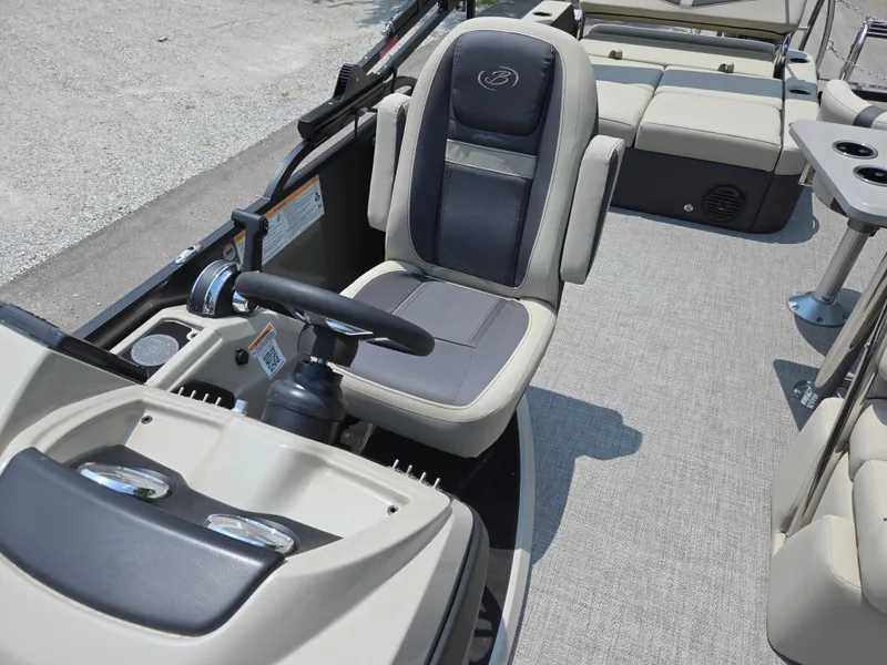Slide: The Image of 2023 Barletta Cabrio 24UE boat interior with steering console and seating. - 14