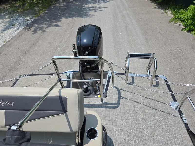 Slide: The Image of 2023 Barletta Cabrio 24UE boat with outboard motor and ladder on a trailer. - 21