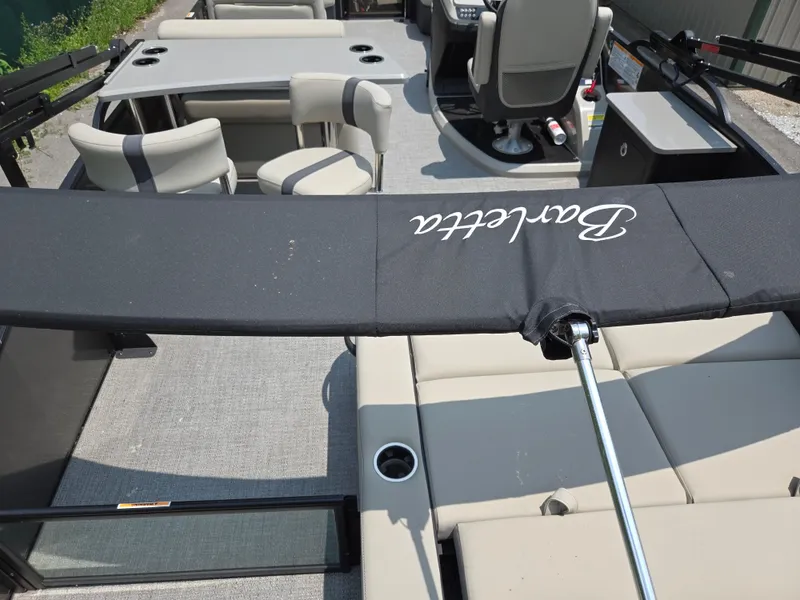 Slide: The Image of 2023 Barletta Cabrio 24UE pontoon boat interior with seating and table setup. - 23
