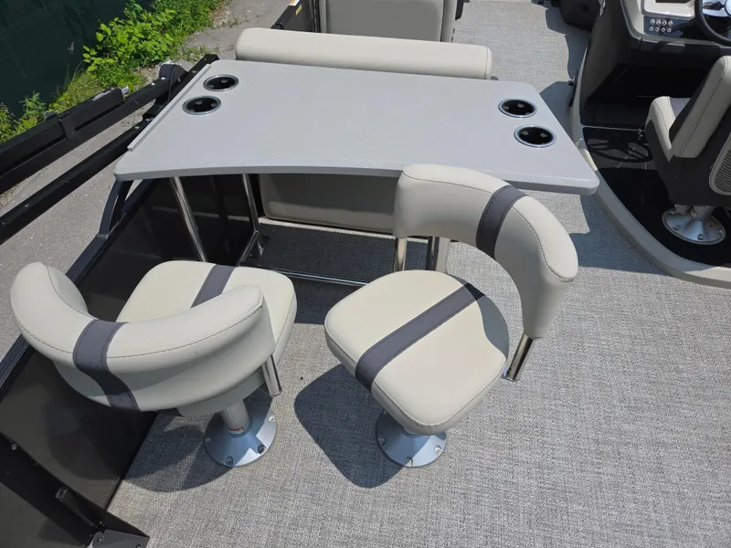 Slide: The Image of 2023 Barletta Cabrio 24UE boat interior with table and swivel chairs. - 24
