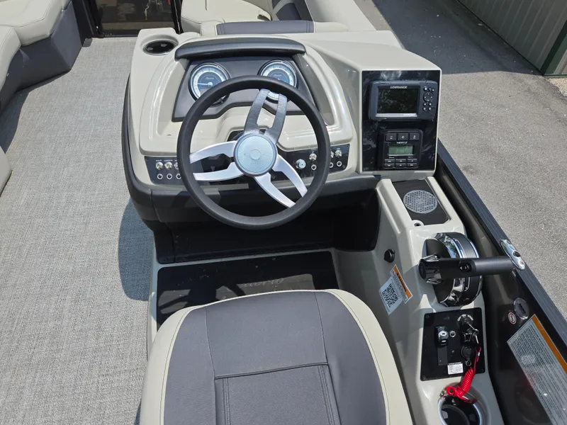 Slide: The Image of 2023 Barletta Cabrio 24UE boat dashboard with steering wheel and control panel. - 25