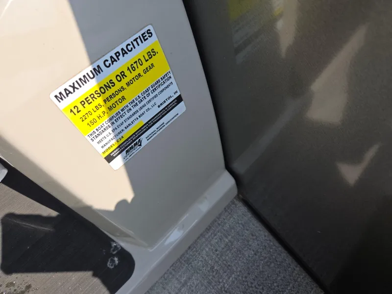 Slide: The Image of 2023 Barletta Cabrio 24UE capacity label, maximum 12 persons or 1670 lbs. - 26