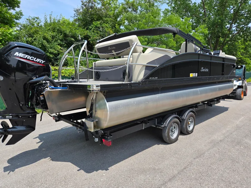 Slide: The Image of 2023 Barletta Cabrio 24UE pontoon boat on trailer, featuring Mercury outboard motor. - 3