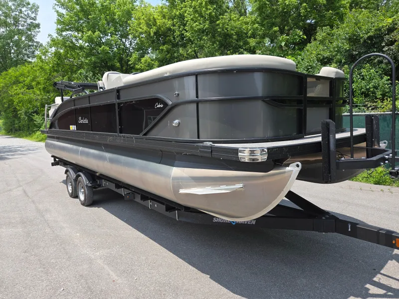 Slide: The Image of 2023 Barletta Cabrio 24UE pontoon boat on trailer, parked on a road. - 5