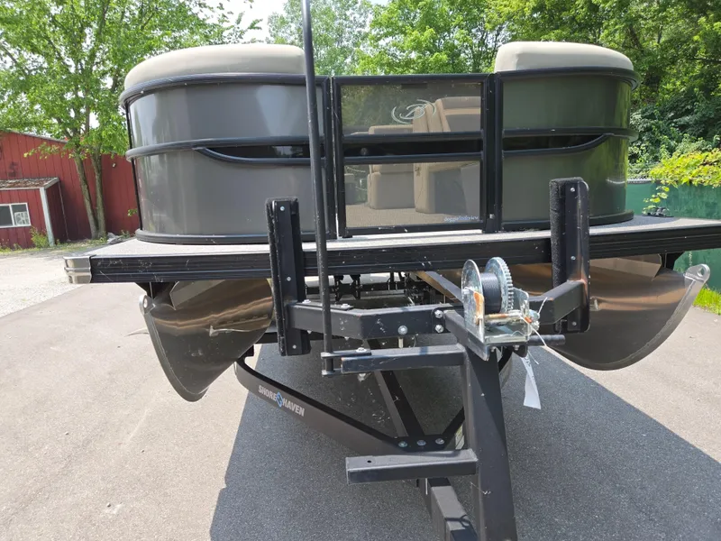 Slide: The Image of 2023 Barletta Cabrio 24UE pontoon boat on trailer, parked outdoors. - 6