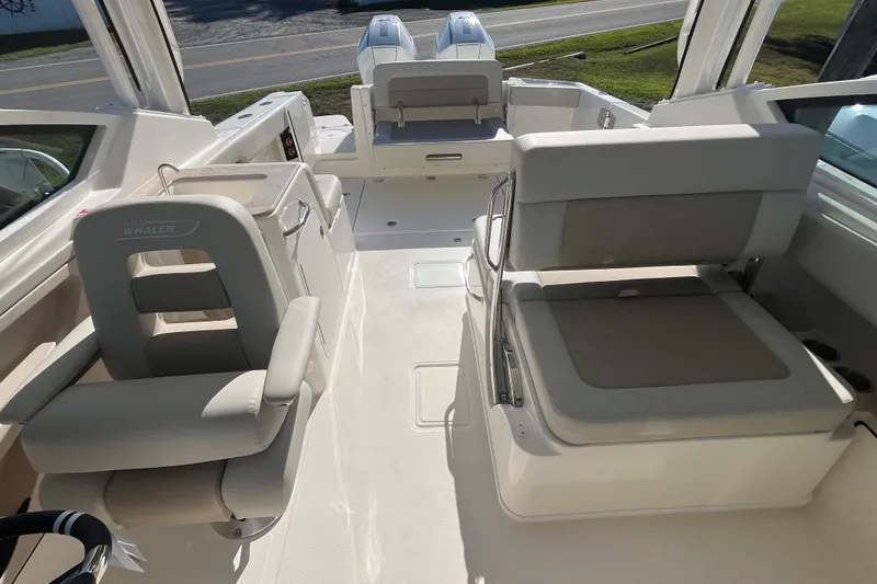 Slide: The Image of 2026 Boston Whaler 280 Vantage boat interior with seating and helm station. - 11