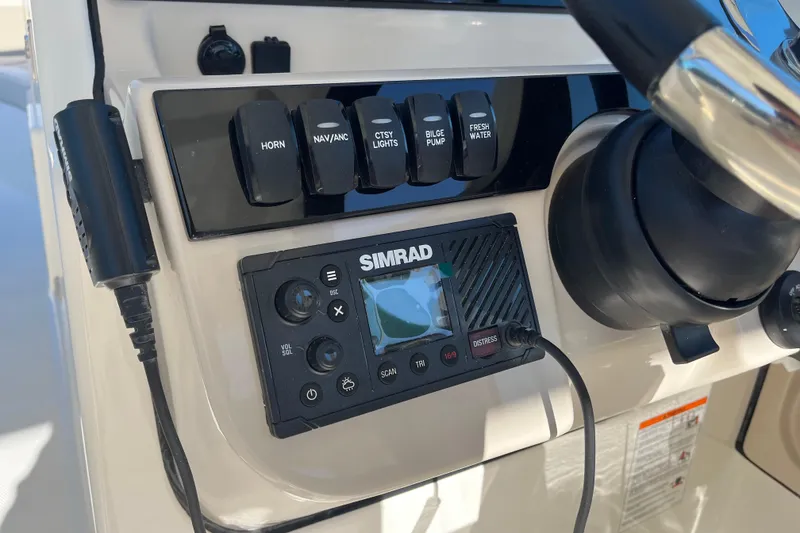 Slide: The Image of Control panel of 2026 Boston Whaler 280 Vantage with Simrad system and switches. - 15