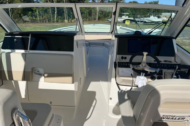 Slide: The Image of Interior view of 2026 Boston Whaler 280 Vantage boat cockpit with steering wheel and controls. - 16