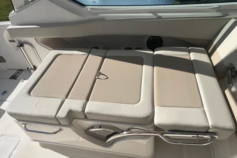 Slide: The Image of 2026 Boston Whaler 280 Vantage boat interior with beige cushioned seating. - 20