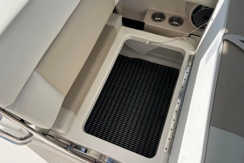 Slide: The Image of 2026 Boston Whaler 280 Vantage boat storage compartment with seating and cup holders. - 24