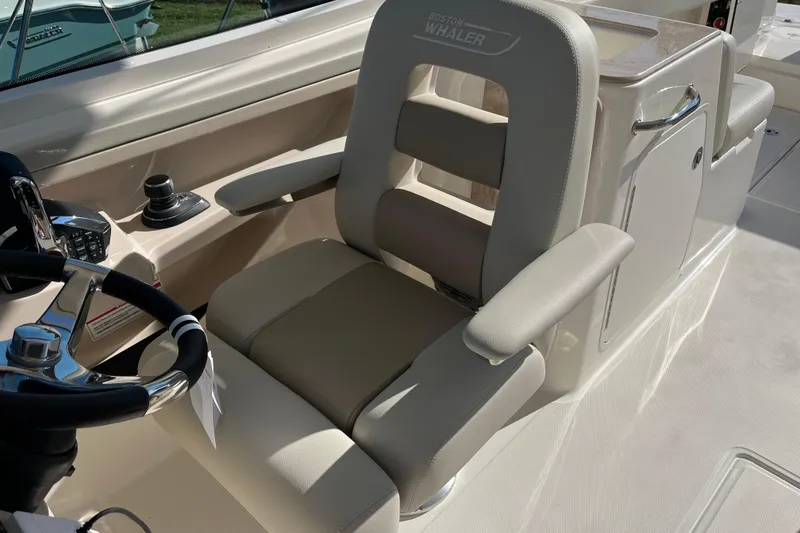 Slide: The Image of 2026 Boston Whaler 280 Vantage boat interior with steering wheel and seating. - 26