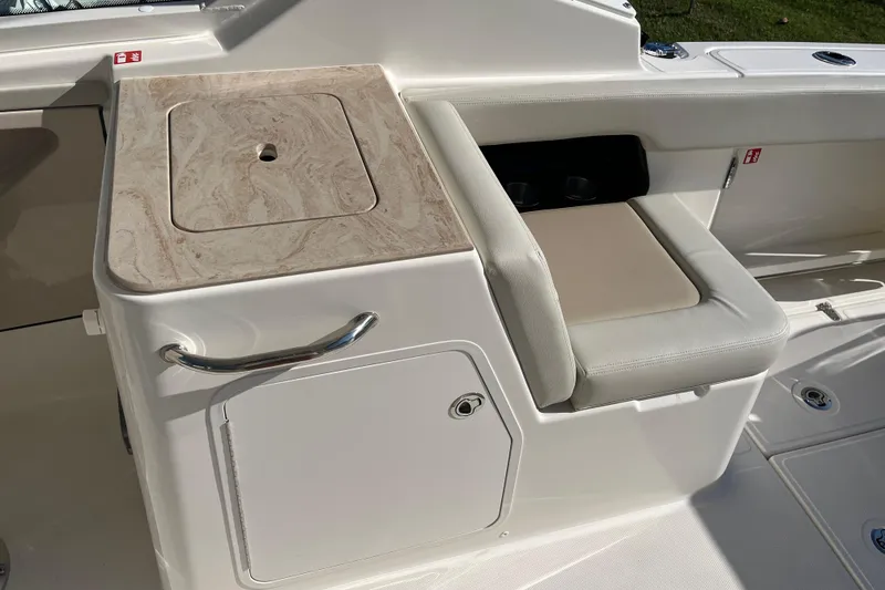 Slide: The Image of 2026 Boston Whaler 280 Vantage interior with seating and storage compartment. - 28