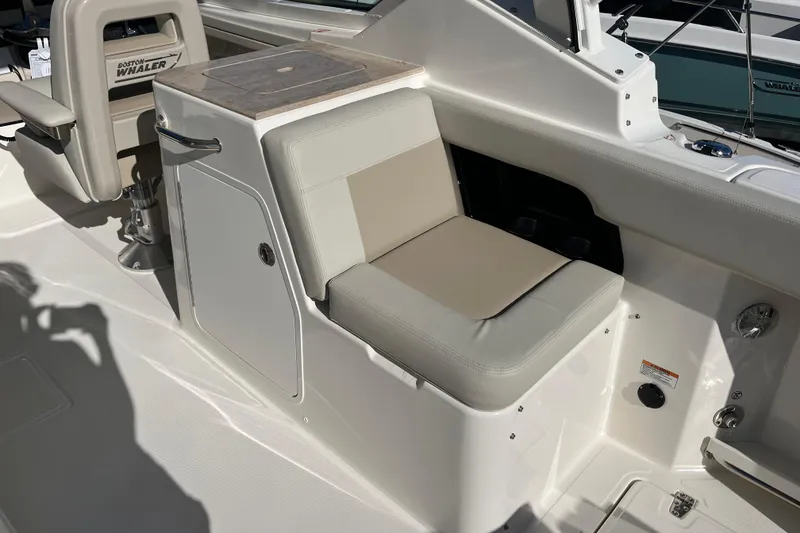 Slide: The Image of 2026 Boston Whaler 280 Vantage interior seating with storage compartment and modern design. - 32