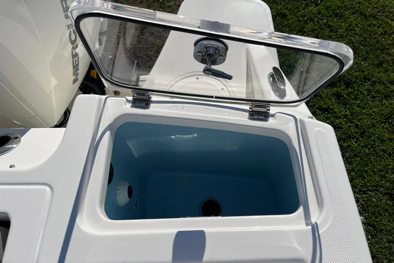 Slide: The Image of Open storage compartment on 2026 Boston Whaler 280 Vantage boat, featuring a clear lid. - 34