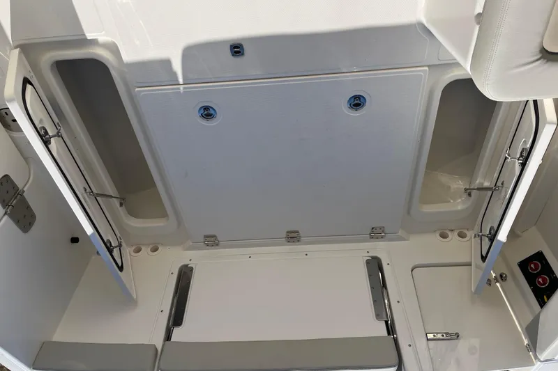 Slide: The Image of 2026 Boston Whaler 280 Vantage storage compartments with open hatches and seating area. - 36