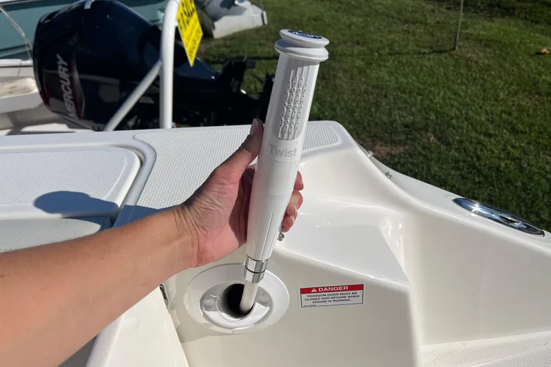Slide: The Image of Hand holding a shower handle on a 2026 Boston Whaler 280 Vantage boat deck. - 38