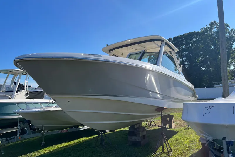 Slide: The Image of 2026 Boston Whaler 280 Vantage boat displayed outdoors on stands. - 43