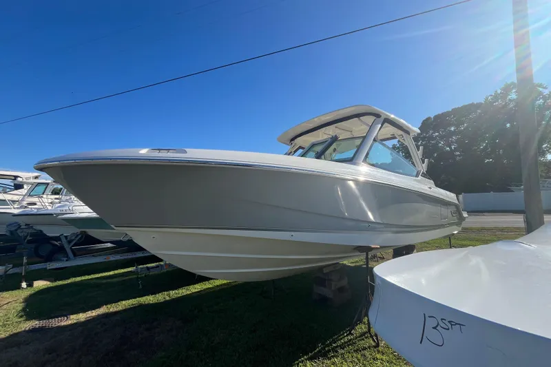 Slide: The Image of 2026 Boston Whaler 280 Vantage boat displayed outdoors under clear blue sky. - 46