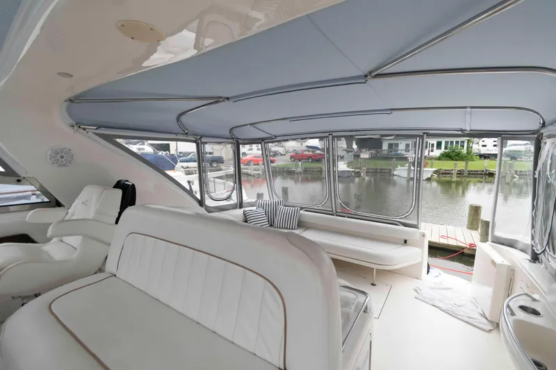 Slide: The Image of Interior of 1998 Sea Ray 450 Sundancer yacht with white seating and waterfront view. - 11