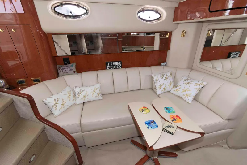 Slide: The Image of Luxurious interior of 1998 Sea Ray 450 Sundancer yacht with plush seating and decorative pillows. - 13