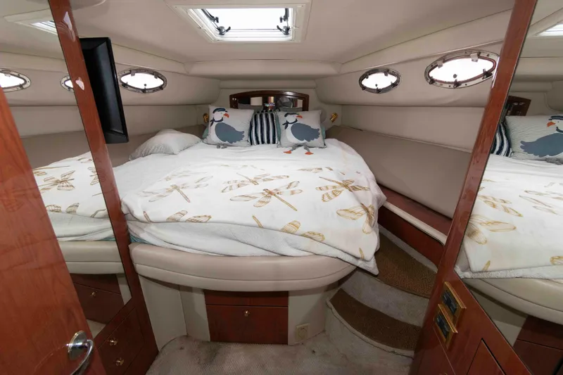 Slide: The Image of Luxurious cabin interior of 1998 Sea Ray 450 Sundancer yacht with cozy bedding. - 16