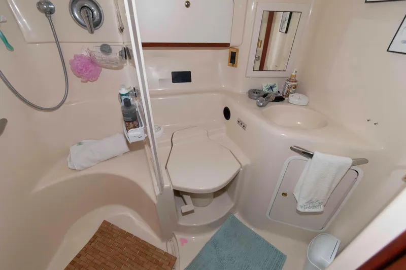 Slide: The Image of Bathroom interior of 1998 Sea Ray 450 Sundancer yacht, featuring shower and sink. - 17