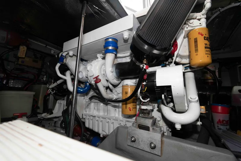 Slide: The Image of Engine room of a 1998 Sea Ray 450 Sundancer with visible components and filters. - 22