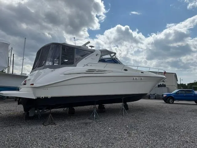 Slide: The Image of 1998 Sea Ray 450 Sundancer yacht on stands, under a cloudy sky. - 3