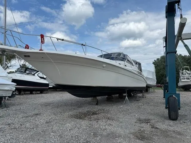 Slide: The Image of 1998 Sea Ray 450 Sundancer yacht on dry dock under cloudy sky. - 4