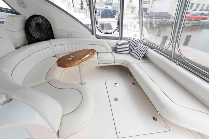 Slide: The Image of Luxurious interior of 1998 Sea Ray 450 Sundancer yacht with white seating and striped cushions. - 6