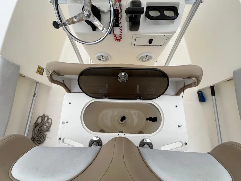 Slide: The Image of 2014 Scout 195 Sportfish boat interior with steering wheel and storage compartments. - 11