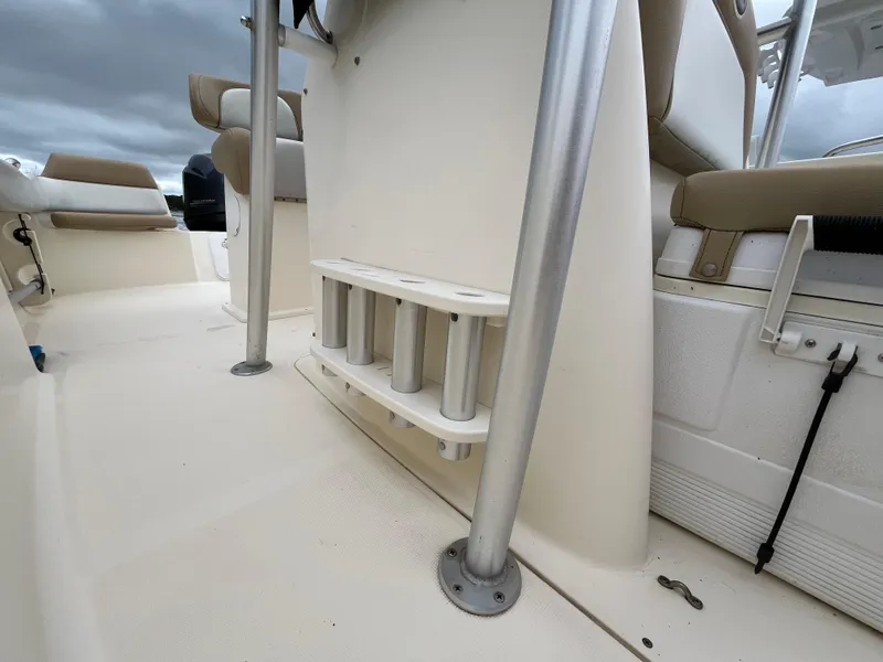 Slide: The Image of 2014 Scout 195 Sportfish boat interior with rod holders and seating. - 22