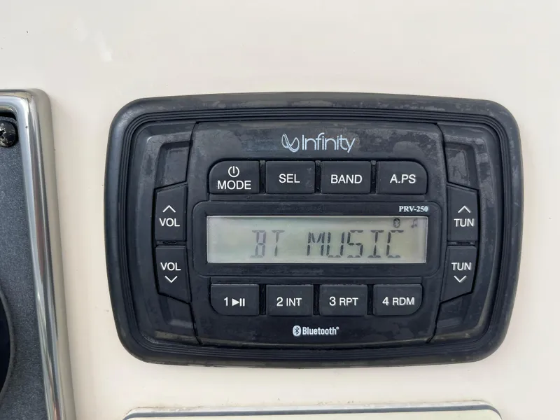 Slide: The Image of Infinity Bluetooth stereo system on 2014 Scout 195 Sportfish boat dashboard. - 26