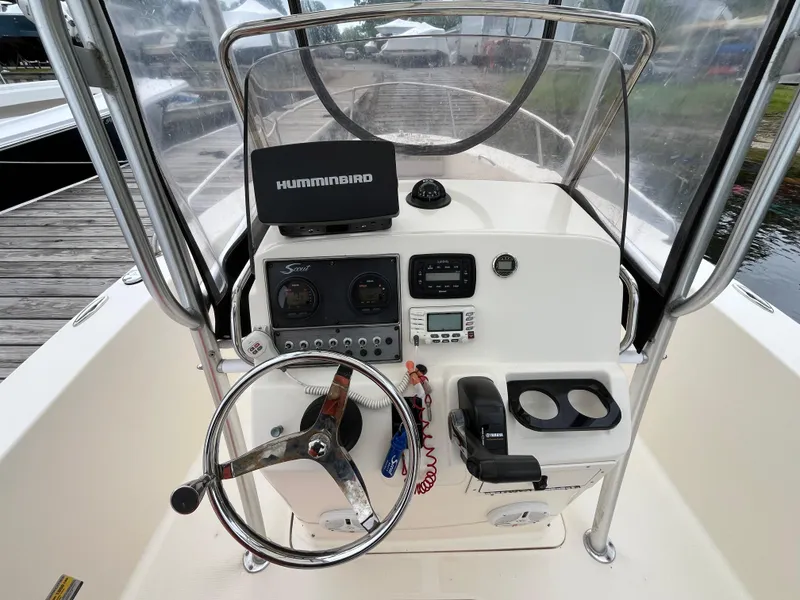 Slide: The Image of 2014 Scout 195 Sportfish boat console with steering wheel and navigation equipment. - 6