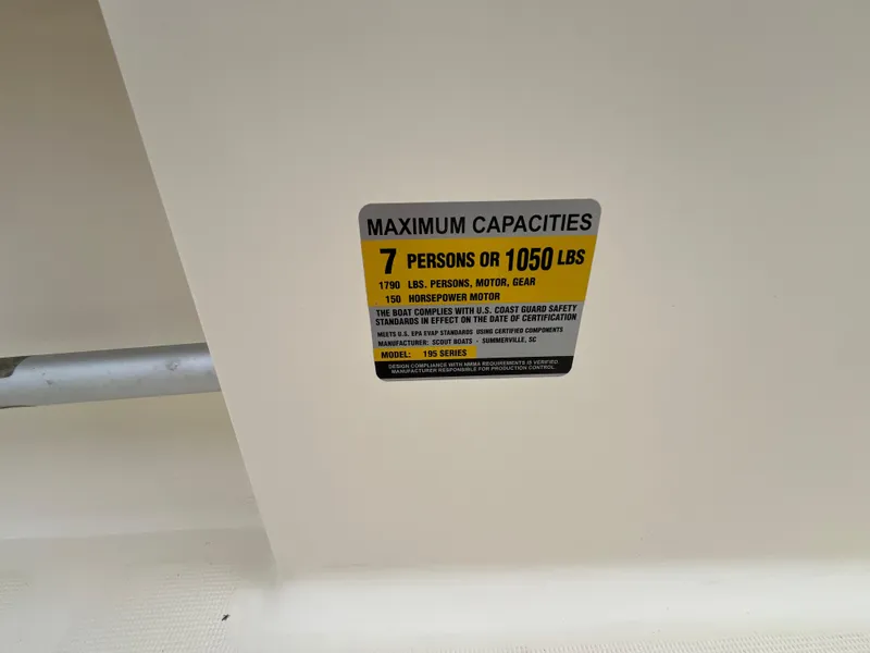 Slide: The Image of 2014 Scout 195 Sportfish capacity label: 7 persons or 1050 lbs maximum. - 7