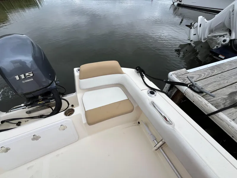 Slide: The Image of 2014 Scout 195 Sportfish boat with Yamaha 115 engine, docked by wooden pier. - 8