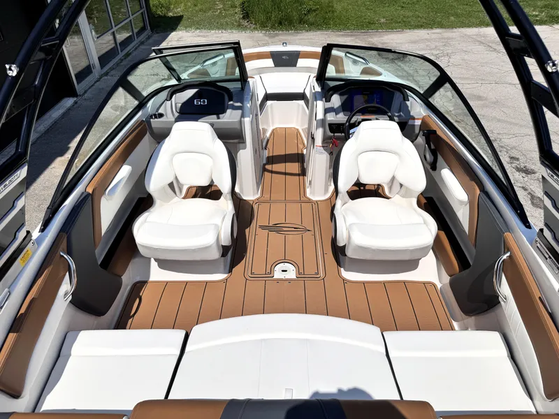 Slide: The Image of 2025 Chaparral 21 SSi OB boat interior with white seats and wood flooring. - 12