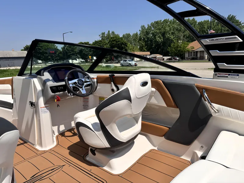 Slide: The Image of 2025 Chaparral 21 SSi OB boat interior with modern steering and seating. - 13