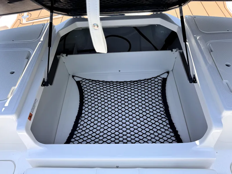 Slide: The Image of 2025 Chaparral 21 SSi OB boat storage compartment with netting. - 15
