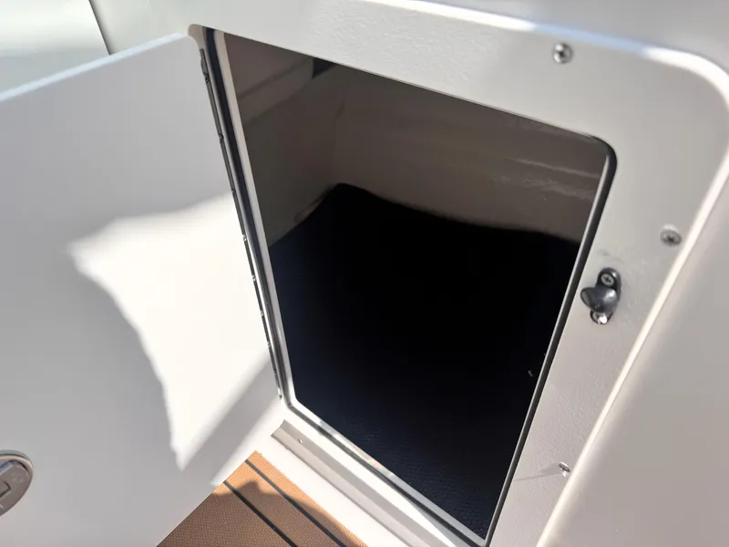 Slide: The Image of Open storage compartment on 2025 Chaparral 21 SSi OB boat. - 18