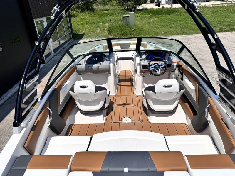 Slide: The Image of 2025 Chaparral 21 SSi OB boat interior with sleek seating and modern dashboard design. - 21