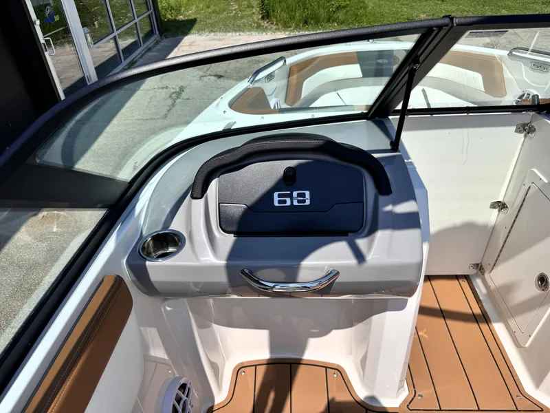 Slide: The Image of 2025 Chaparral 21 SSi OB boat dashboard with steering wheel and seating area. - 24