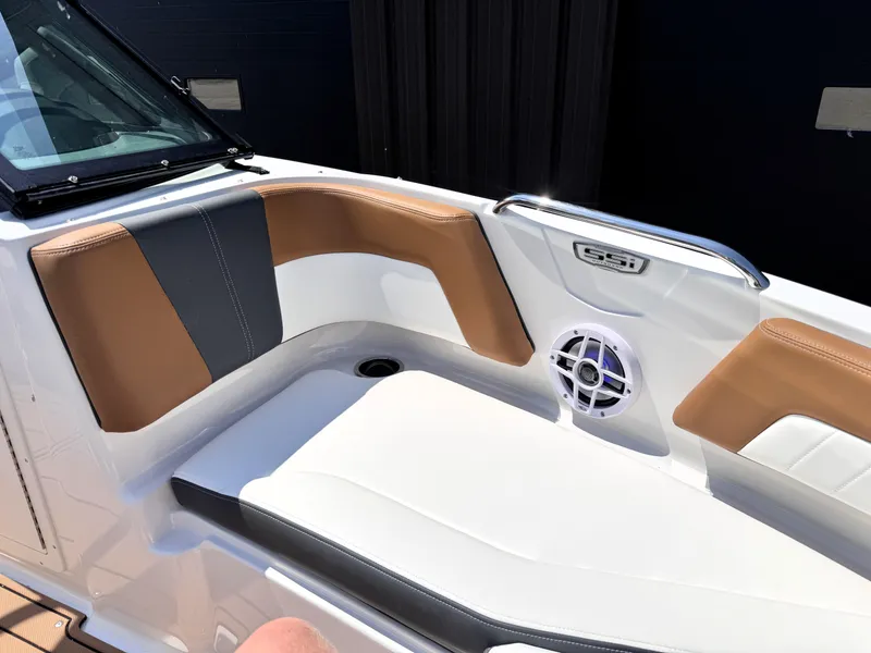 Slide: The Image of 2025 Chaparral 21 SSi OB boat interior with tan and gray seating, speaker, and cup holder. - 27