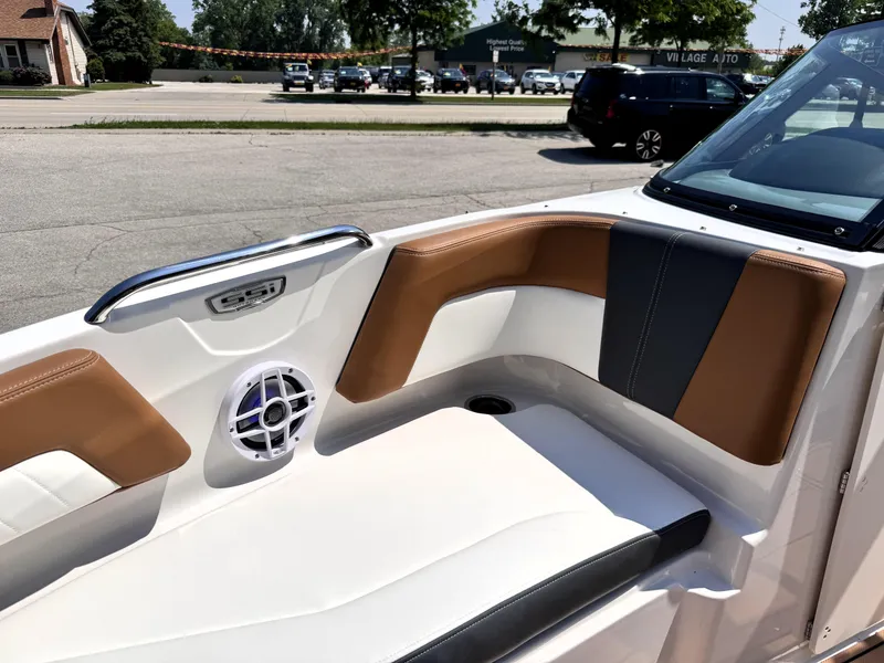 Slide: The Image of 2025 Chaparral 21 SSi OB boat interior with tan and black seating, speaker, and handle. - 28