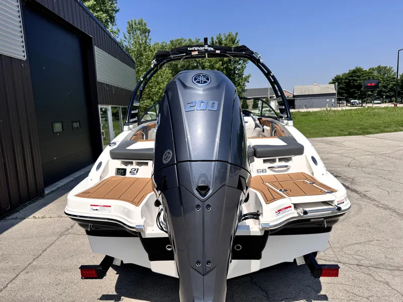 Slide: The Image of 2025 Chaparral 21 SSi OB boat with Yamaha outboard motor, parked outdoors. - 3
