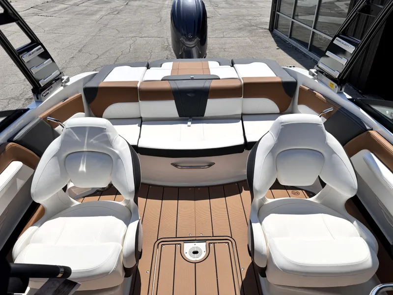 Slide: The Image of 2025 Chaparral 21 SSi OB boat interior with white and tan seating, modern design. - 4