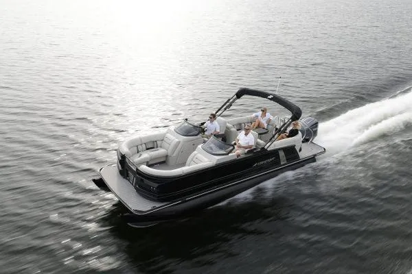 The Image of 2026 Starcraft RX 23 R DC pontoon boat on trailer, outdoor setting, sunny day. - 0