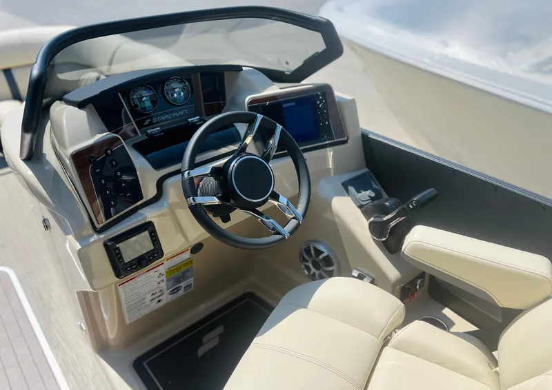 Slide: The Image of 2026 Starcraft RX 23 R DC boat interior with beige seating and storage compartment. - 11